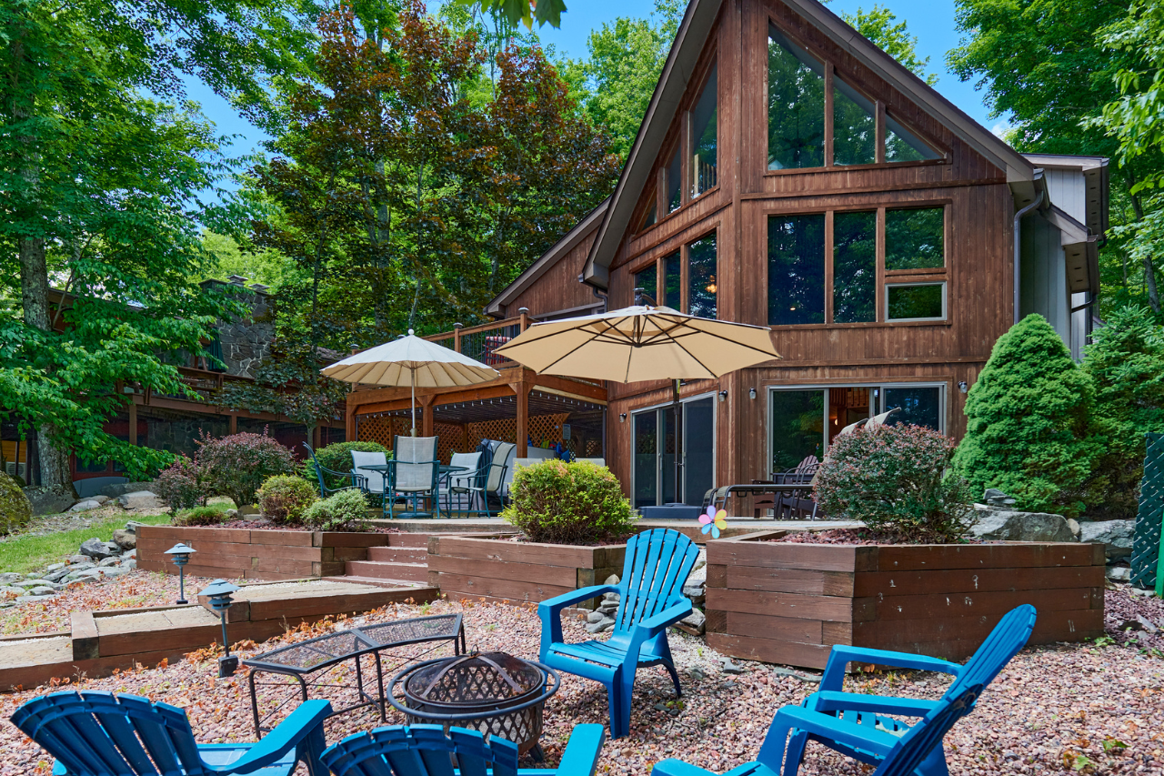 House with outdoor sitting area and blue chairs